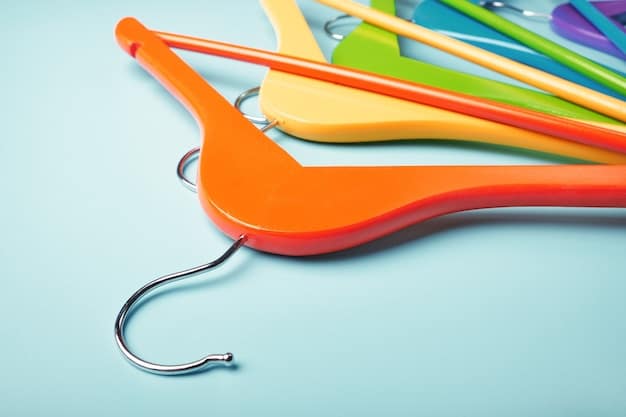 A close-up of slim velvet hangers neatly holding a variety of clothes in a closet. The hangers are all the same style and colour, creating a uniform and organised look.