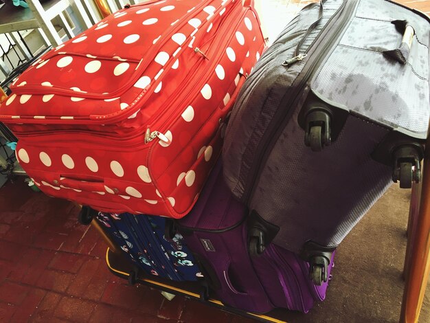 A set of various types of luggage, including a hard-shell suitcase, a soft-shell suitcase, a travel backpack, and a rolling suitcase, displayed against a neutral background to showcase their differences in size, material, and features.