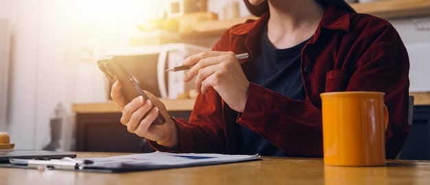 A person on the phone looking thoughtfully at a credit card and a statement. They are making calculations on a notepad, highlighting key numbers.