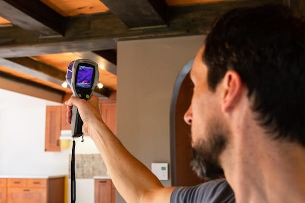 An energy auditor using a thermal imaging camera to check for heat loss in a home. The focus is on identifying areas with poor insulation.