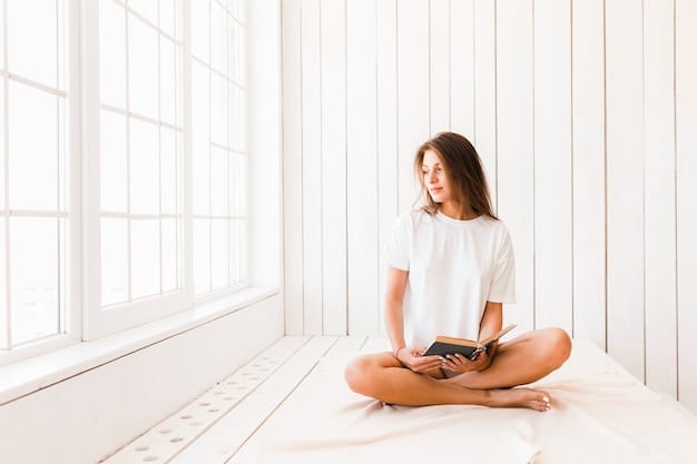 A person sitting cross-legged on a yoga mat, eyes closed, meditating in a peaceful living room. Soft natural light streams through the window.