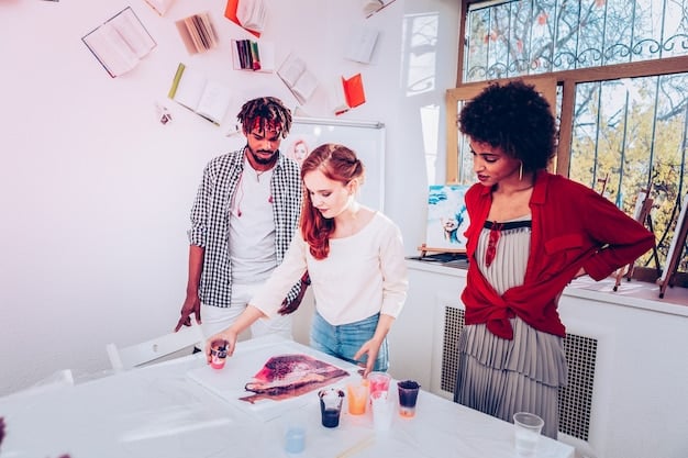 A group of artists working together in a studio, creating a large mural with various colours and styles, representing collaboration and shared creativity.