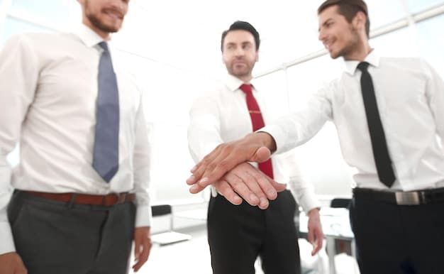A close-up shot of a leader shaking hands with a team member, both smiling genuinely. The handshake is firm and the body language conveys respect and mutual understanding, emphasizing the importance of personal connection in leadership.