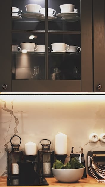 A close-up showcasing under-cabinet LED lighting illuminating a clean countertop with modern kitchen utensils and accessories.