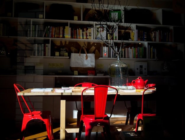 A converted cellar serves as a functional home office setup, complete with a tidy desk, ergonomic chair, sufficient lighting, and bookshelves.