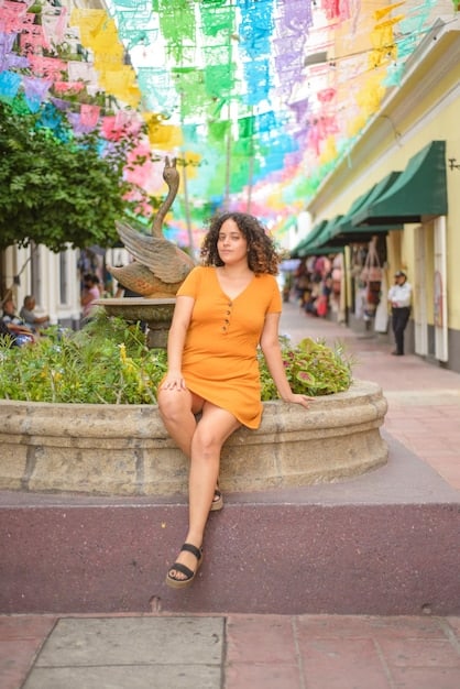 A plus-size woman modeling a vibrant, long maxi skirt paired with a snug, solid-colored top, demonstrating a chic and comfortable outfit combination from Shein.