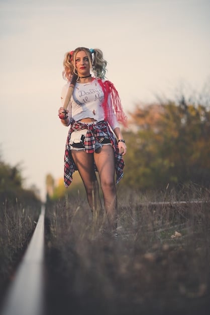 A person at a vibrant outdoor music festival, confidently posing in Shein cargo pants, combat boots, and layered bohemian-edgy accessories, capturing the energetic and free-spirited vibe.