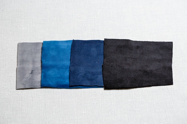 A detailed flat lay of various monochrome fabric swatches in different textures (silk, knit, denim) with Shein labels.