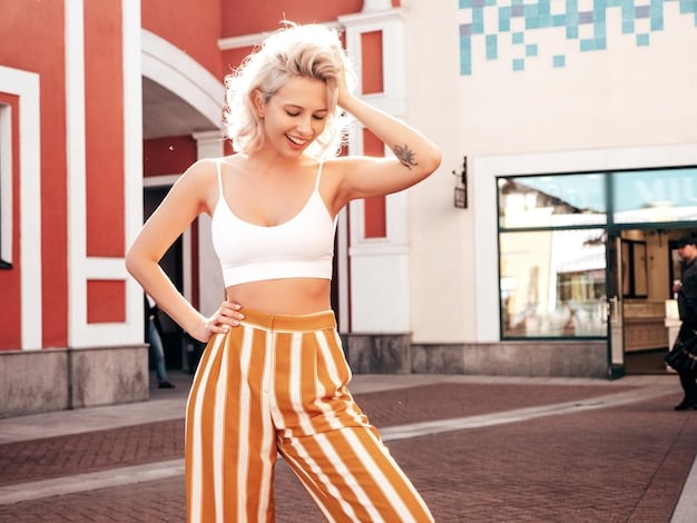 A trendy person wearing a stylish Shein loungewear set (cropped top and high-waisted joggers) in a bold color like cobalt blue, paired with chunky white sneakers and a sleek mini backpack, looking effortlessly cool while on an urban street.