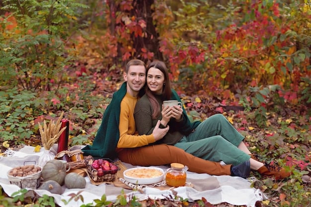 A diverse group of friends enjoying a fall picnic, one wearing a vibrant terracotta sweater and another in a deep mustard dress from Shein's Fall 2025 collection.