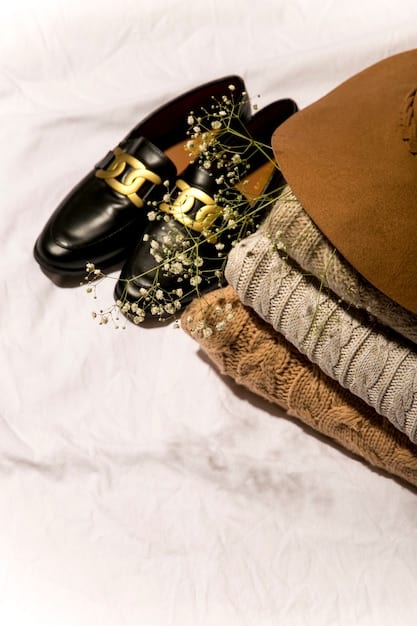 A detailed flat lay of Shein's Fall 2025 accessories, featuring a bronze metallic clutch, pewter chunky necklace, and a dusty rose silk scarf, all against a dark wood background.