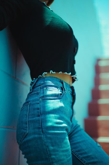 A close-up shot of a Shein model's torso, clearly showing the waistband of a pair of high-rise, dark-wash skinny jeans, highlighting the fit around the waist and hips.
