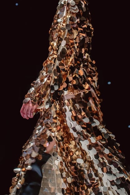 A detailed shot of an evening outfit from Shein, featuring a sequined animal print top paired with a flowing abstract floral skirt, suggesting a daring yet elegant aesthetic for a night out in 2025.