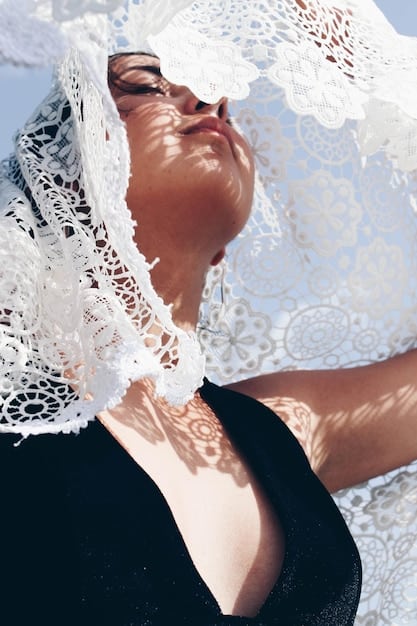 A close-up shot of a model wearing an embellished Shein top, with the rest of her outfit blurred in the background, emphasizing the intricate details of the statement piece.