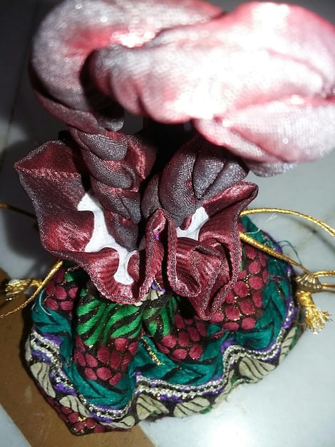 A close-up shot of a variety of colorful Shein scarves artfully tied and arranged in different ways – as a headband, around a handbag handle, and as a makeshift belt – demonstrating their versatility.