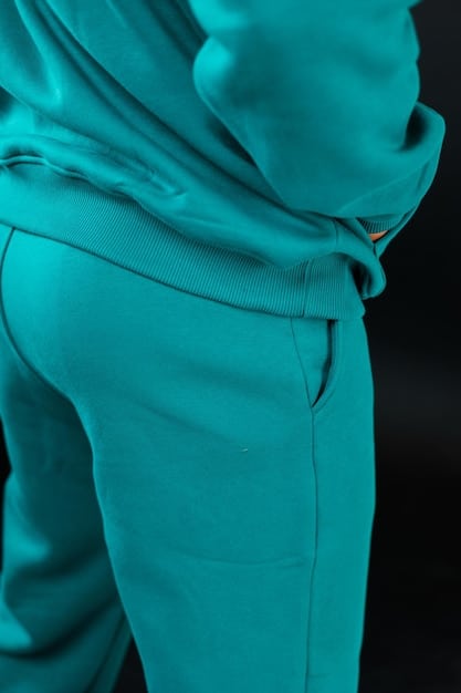 A close-up shot of a seamlessly knitted compression leggings fabric from Shein, highlighting its texture and stretch, with a blurred background of a fashion studio.