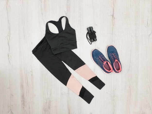 A flat lay of a Shein activewear set, including high-waisted leggings and a matching sports bra, artistically arranged with a chunky knit cardigan, a minimalist watch, and a stylish pair of sunglasses on a warm wooden surface.