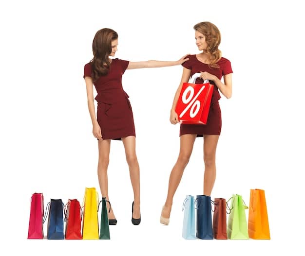A young woman comparing two identical Shein dresses, one with a 15% discount tag and the other on a flash sale, illustrating smart shopping decisions.