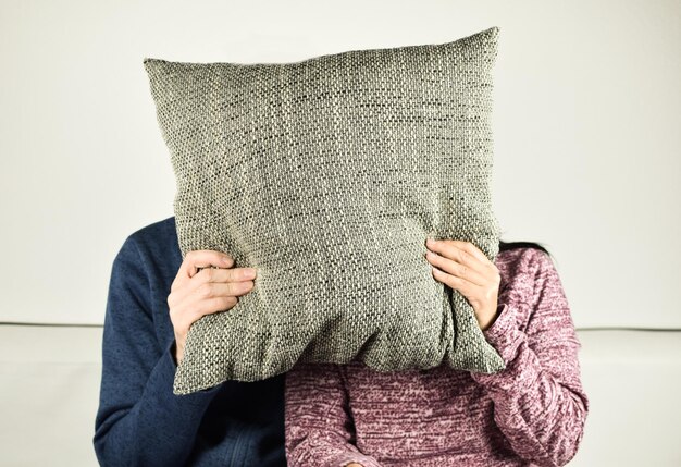 A close-up of a Shein Home throw pillow showing signs of pilling and a broken zipper, illustrating wear and tear.