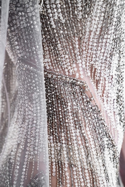 A close-up shot of a Shein party dress with intricate sequin detailing, showcasing the fabric texture and sparkle under soft lighting, highlighting its quality.